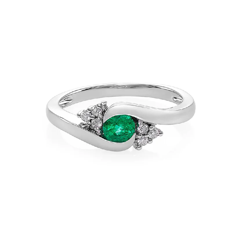 Cathedral - Style Engagement Rings with a Raised Center Stone and Intricate MetalworkEmerald and Diamond Ring in White Gold Cathedral - Style Engagement Rings with a Raised Center Stone and Intricate MetalworkEmerald and Diamond Ring in White Gold