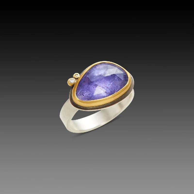 Iolite Gemstone Rings in 10K Gold with a Twisted Band for a Distinctive and Stylish AccessoryRose Cut Tanzanite Ring with Two Diamond Dots Iolite Gemstone Rings in 10K Gold with a Twisted Band for a Distinctive and Stylish AccessoryRose Cut Tanzanite Ring with Two Diamond Dots