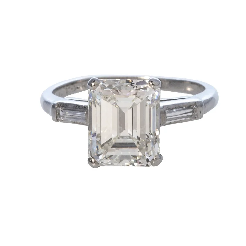 Engagement - Inspired Women's Rings with a Halo of Small DiamondsEstate 3ct Emerald-Cut & .10ct Baguette Side Diamond Platinum Ring Engagement - Inspired Women's Rings with a Halo of Small DiamondsEstate 3ct Emerald-Cut & .10ct Baguette Side Diamond Platinum Ring